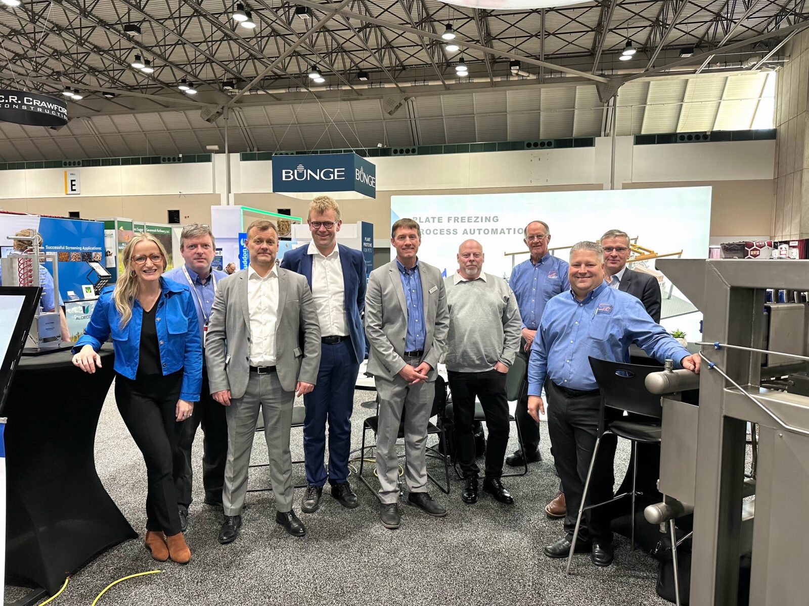 Group photo of the Scan American team with European partners inside the booth at Petfood Forum 2023.