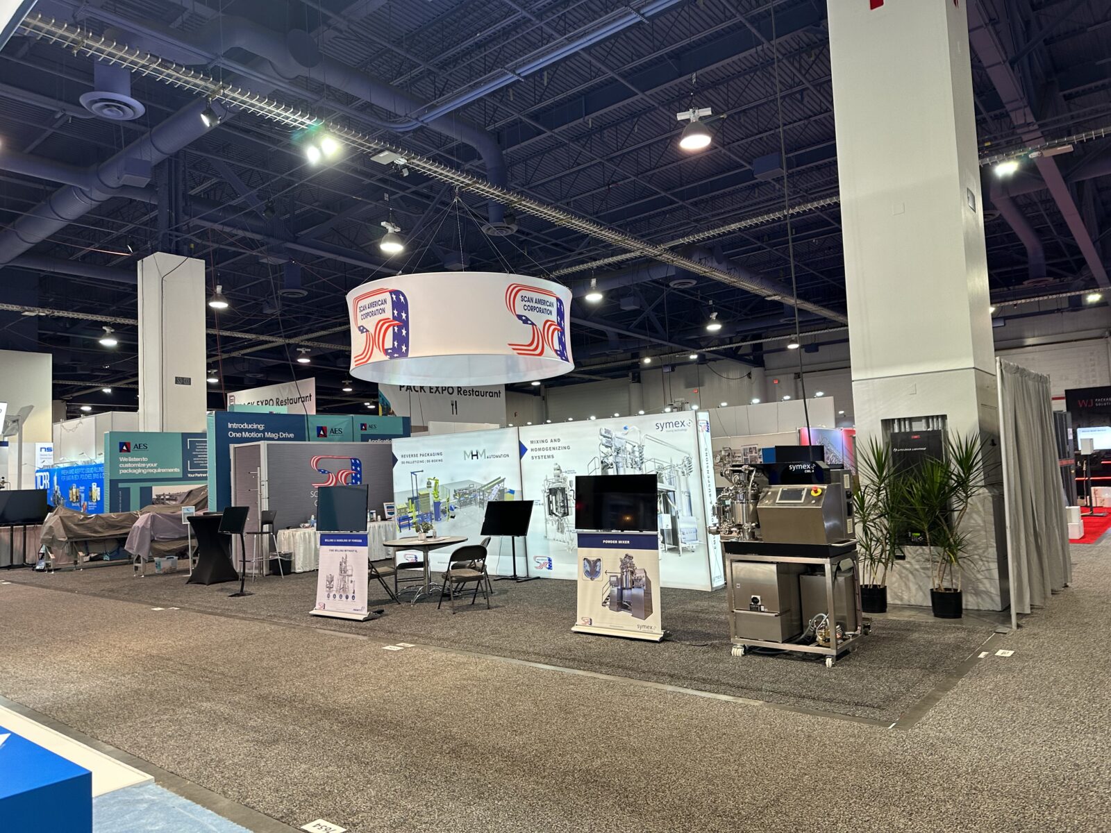Wide shot of the Scan American booth at Pack Expo 2023 with no people present.