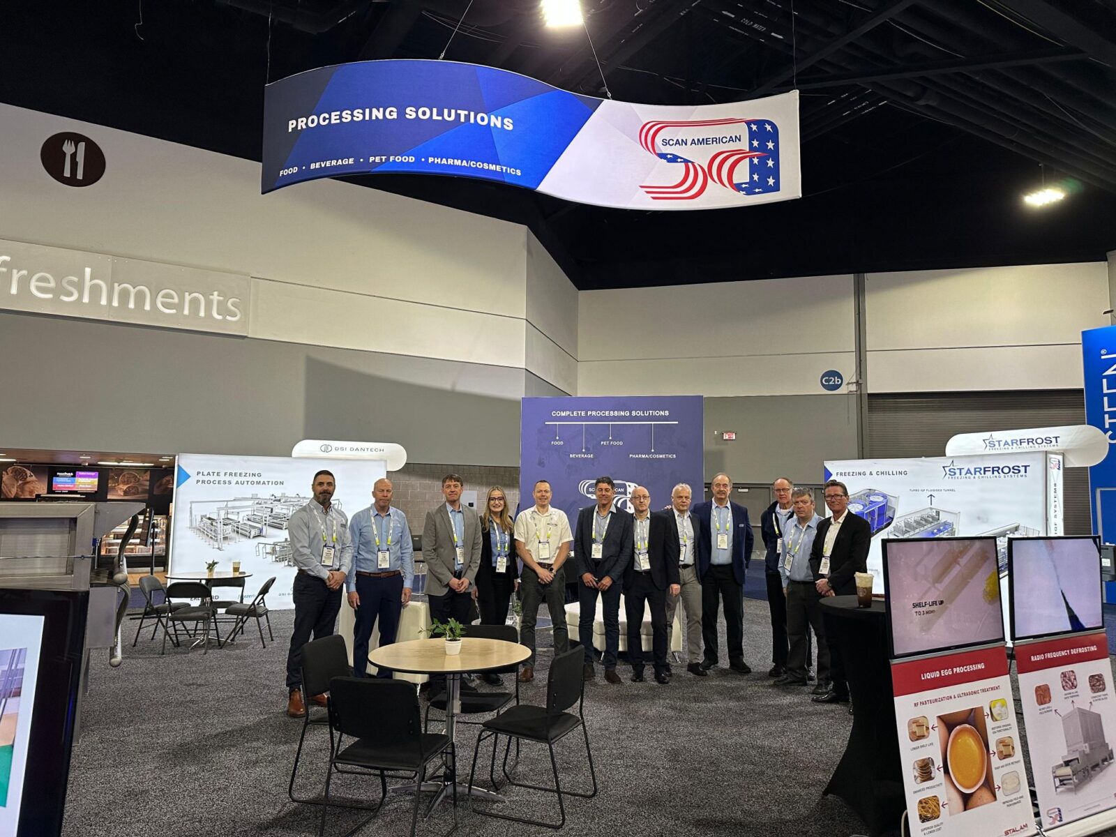 Group photo of the Scan American team with international partners Thomas Jørgensen (Erlinord), Jens Renken (Vetec), Jonathan Fox (Starfrost), Jimmy Larsen (Jimco), and Davide Amatori (Stalam) at the IPPE 2025 booth.