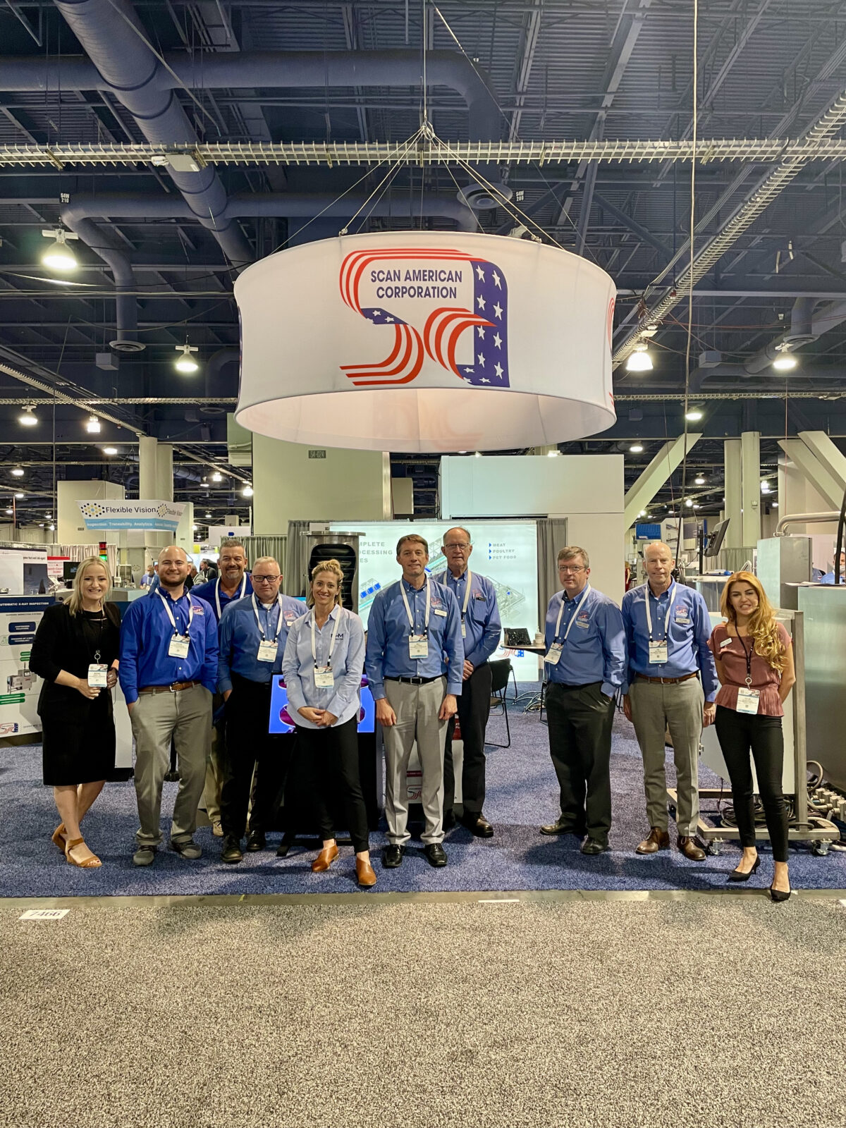 Group photo of the Scan American team and representatives from vendor partners in front of the booth at Pack Expo 2021.